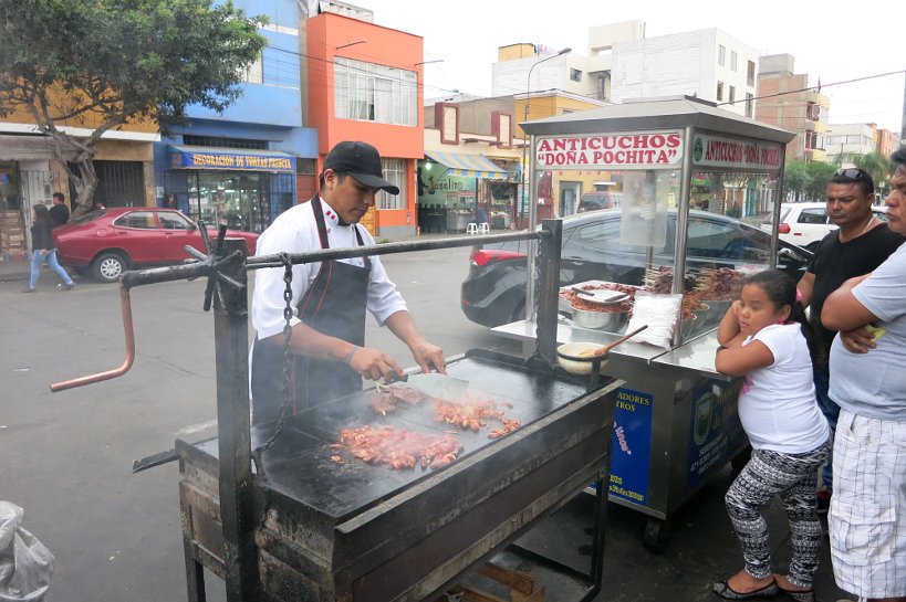 dona pochita street cart Grilling Anticuchos a popular peru street food in Lima by Authentic Food Quest