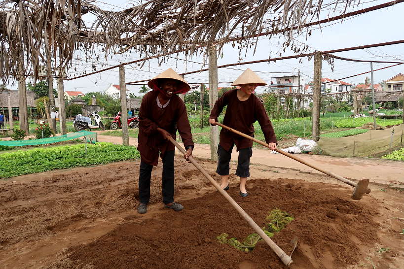 Rosemary and Claire preparing the soil in Tra Que Village by Authentic Food Quest