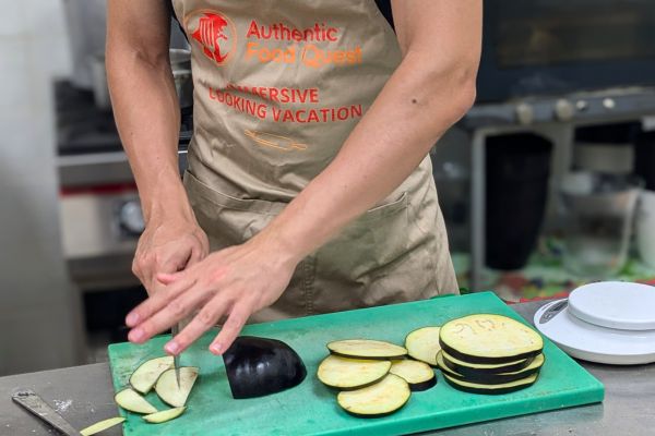 Chris cutting eggplants for parmigiana for our cooking vacations in Puglia 2024